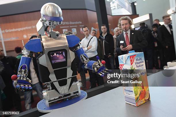 Robot developed by the Karlsruhe Institute of Technology attempts to retrieve a carton of juice in a presentation on the first day of the CeBIT 2012...