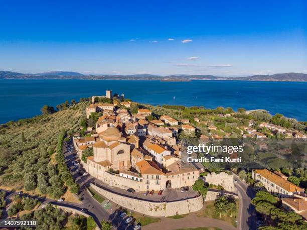 castiglione del lago, italian lake town in umbria region from drone - lake trasimeno stock pictures, royalty-free photos & images