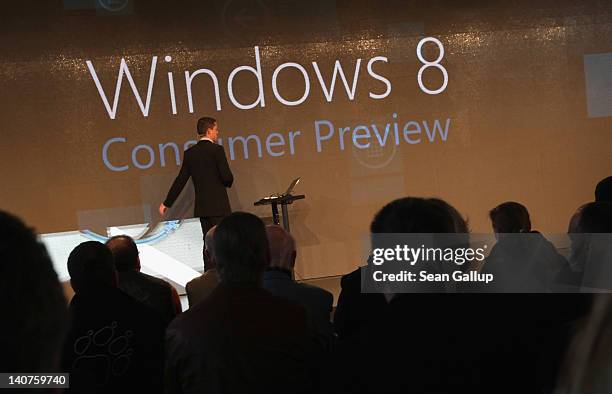 Visitors watch a presentaiton of fetaures of the new Windows 8 operating system at the Microsoft stand on the first day of the CeBIT 2012 technology...