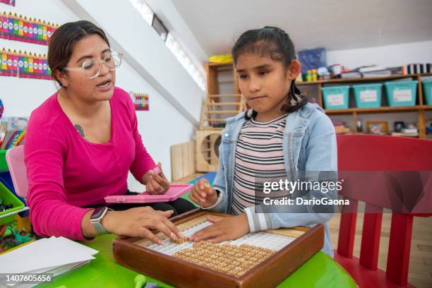 teacher teaching math to blind girl - blindness imagens e fotografias de stock