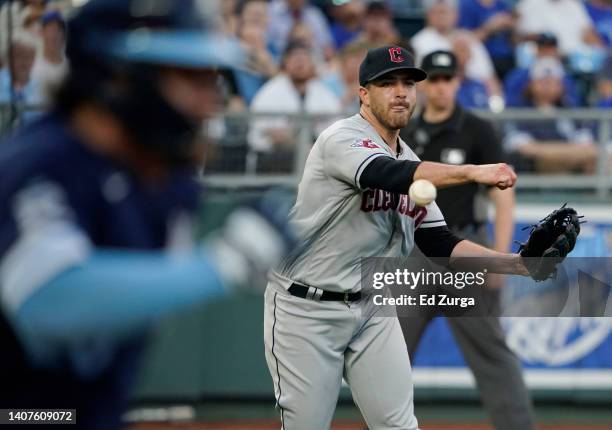 Aaron Civale of the Cleveland Guardians throws to first to get the out on Kyle Isbel of the Kansas City Royals in the fifth inning at Kauffman...