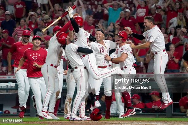 Tyler Naquin of the Cincinnati Reds celebrates with teammates after Matt Wisler of the Tampa Bay Rays balked to end the game 2-1 in the tenth inning...