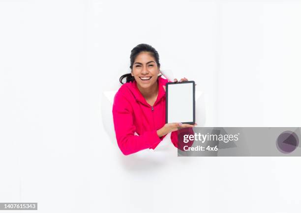 generation z young women in front of white background wearing sweatshirt and using touch screen - fab fragment stock pictures, royalty-free photos & images