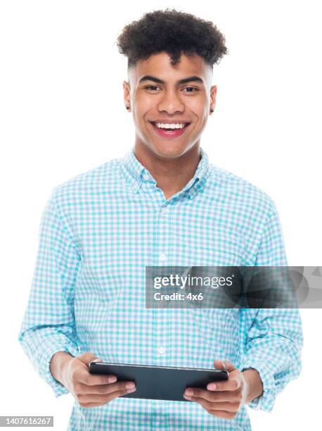 african ethnicity young male standing in front of white background wearing shirt and using touch screen - man ipad isolated stock pictures, royalty-free photos & images