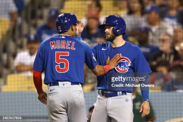 Christopher Morel of the Chicago Cubs celebrates with his teammate David Bote after scoring against the Los Angeles Dodgers during the fifth inning...