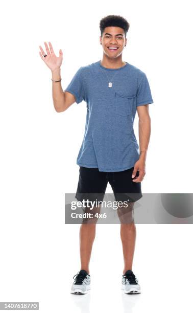 generation z teenage boys standing in front of white background wearing sports shoe - curly waves stock pictures, royalty-free photos & images