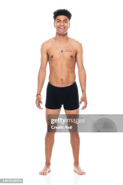 african ethnicity male standing in front of white background wearing boxer shorts - black shorts stock pictures, royalty-free photos & images
