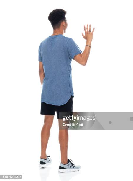 generation z teenage boys standing in front of white background wearing t-shirt - curly waves stock pictures, royalty-free photos & images
