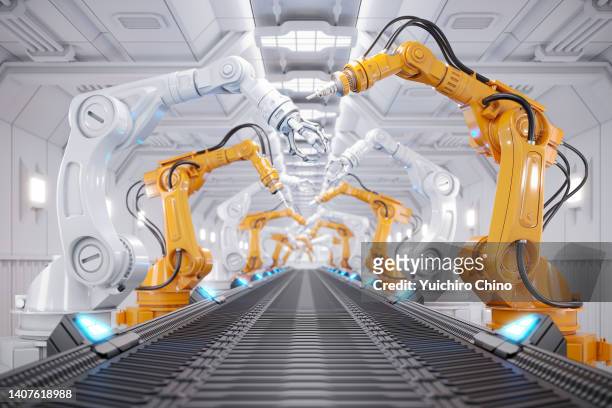robotic arm in futuristic assembly manufacturing factory - robotics stock-fotos und bilder