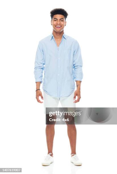 african ethnicity male standing in front of white background wearing canvas shoe - black hair isolated stock pictures, royalty-free photos & images