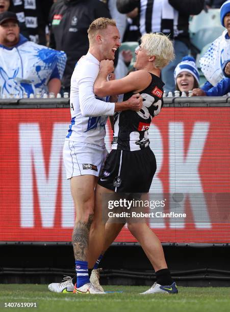 Jaidyn Stephenson of the Kangaroo wrestles with Jack Ginnivan of the Magpies during the round 17 AFL match between the Collingwood Magpies and the...