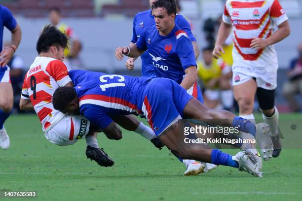 Naoto Saito of Japan is tackled by Virimi Vakatawa of France during the rugby international test match between Japan and France at the National...