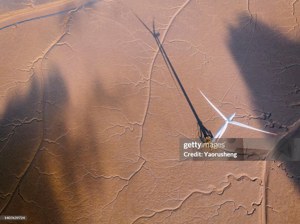 Aerial view of the windmill plant at natural shapes tidal mudflats