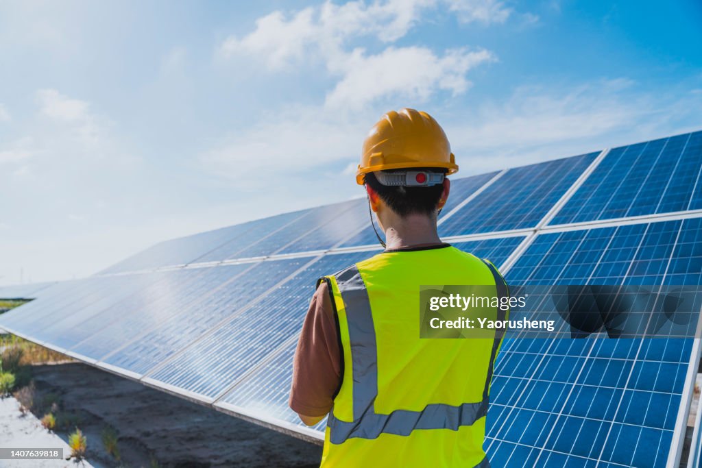 One male engineer checking the solar panel with digital tools