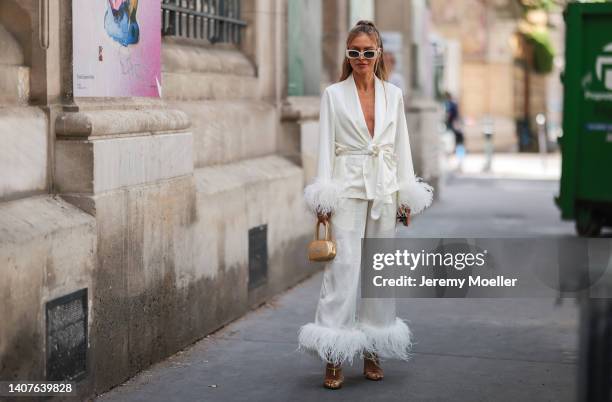 Maja Malnar seen wearing white belted blazer, pants, heels, sunglasses and a mini white creme handbag outside Elie Saab, during Paris Fashion Week -...