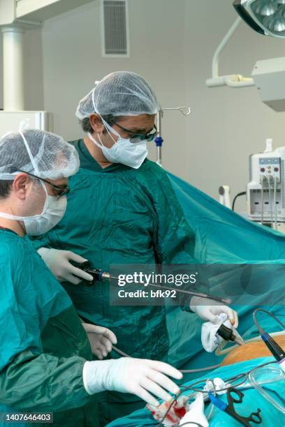 medical professionals performing laparoscopic surgery. - bariatric stock pictures, royalty-free photos & images