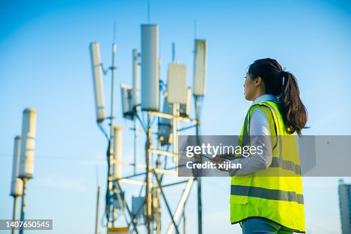 Engineer working at a telecommunications tower Engineer working at a telecommunications tower