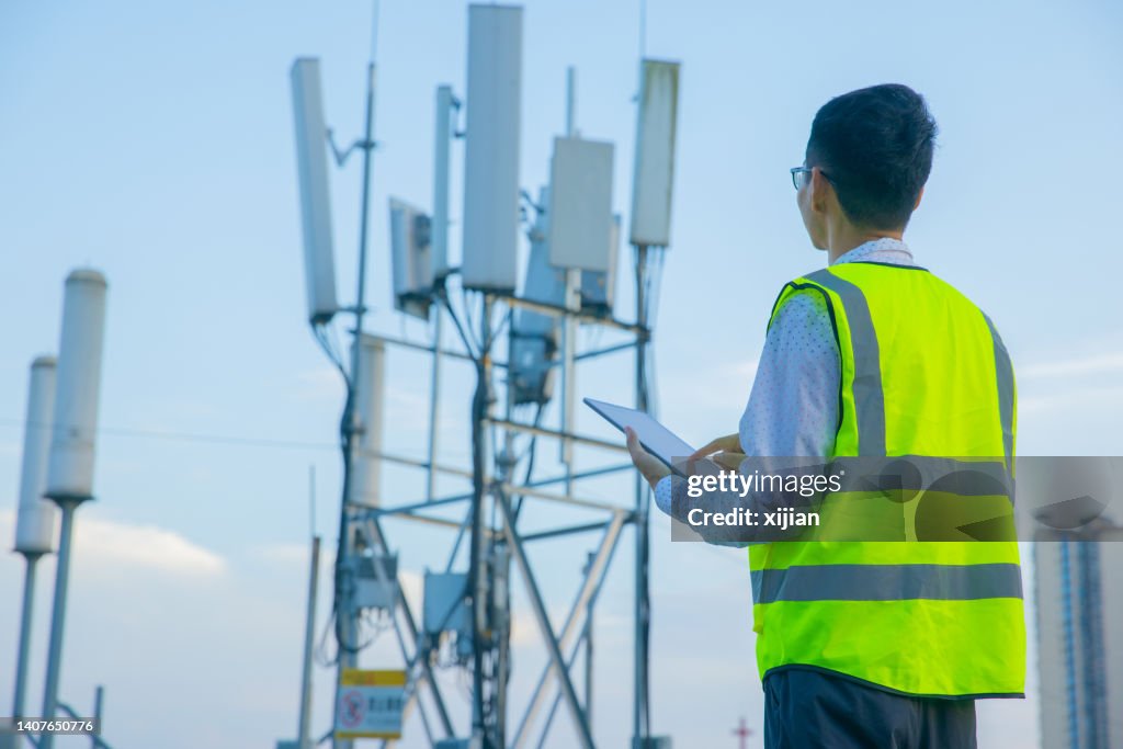 Engineer hand using digital tablet testing the communications tower
