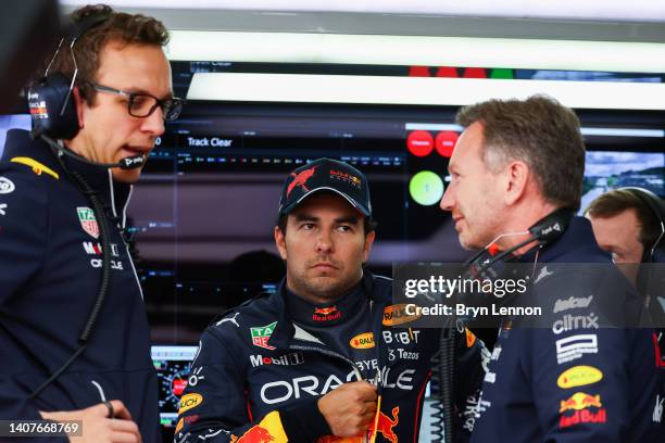 Sergio Perez of Mexico and Oracle Red Bull Racing talks with Red Bull Racing Team Principal Christian Horner and race engineer Hugh Bird in the...