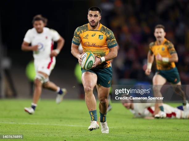 Tom Wright of Australia makes a break during game two of the International Test Match series between the Australia Wallabies and England at Suncorp...