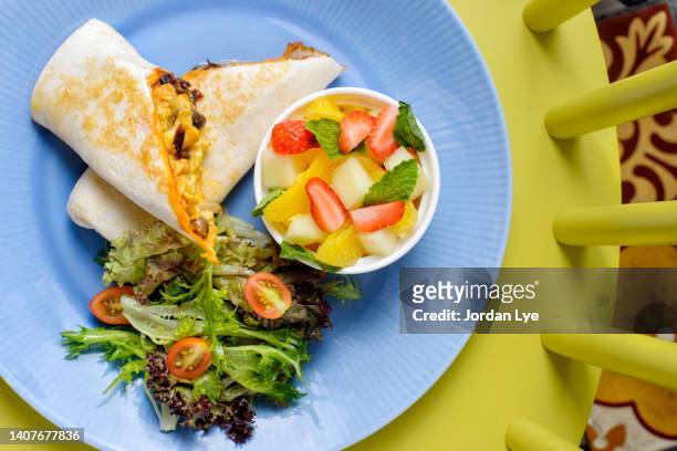 breakfast burrito with fruits salad, flat lay - whole wheat burrito stock pictures, royalty-free photos & images