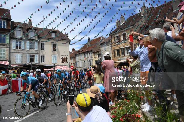 General view of the Peloton passing through Arbois Village while fans cheer during the 109th Tour de France 2022, Stage 8 a 186,3km stage from Dole...