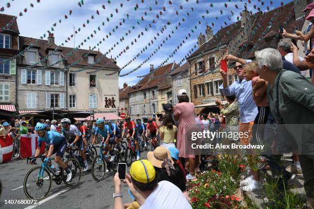 General view of the Peloton passing through Arbois Village while fans cheer during the 109th Tour de France 2022, Stage 8 a 186,3km stage from Dole...