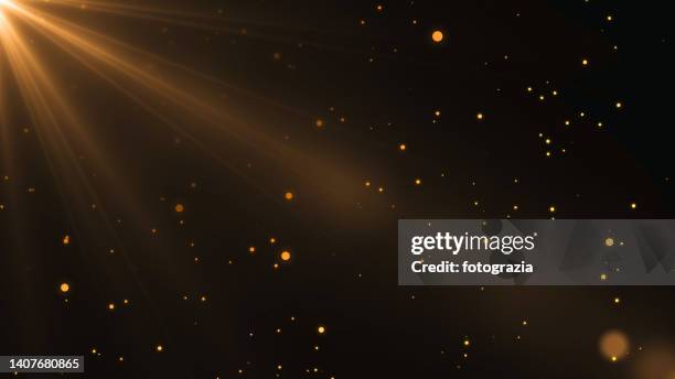 defocused golden lights background - dust dark fotografías e imágenes de stock