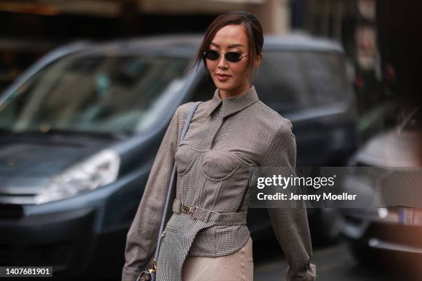 Chriselle Lim is seen wearing a beige blouse, rose beige pants, sunglasses and rose high heels outside Fendi, during Paris Fashion Week - Haute...