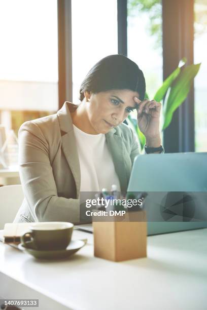 business woman feeling anxious and stressed while struggling with plans and decisions on a laptop in an office. frustrated entrepreneur worried about deadlines in a crisis with slow internet problems - laptop desperate professional stockfoto's en -beelden