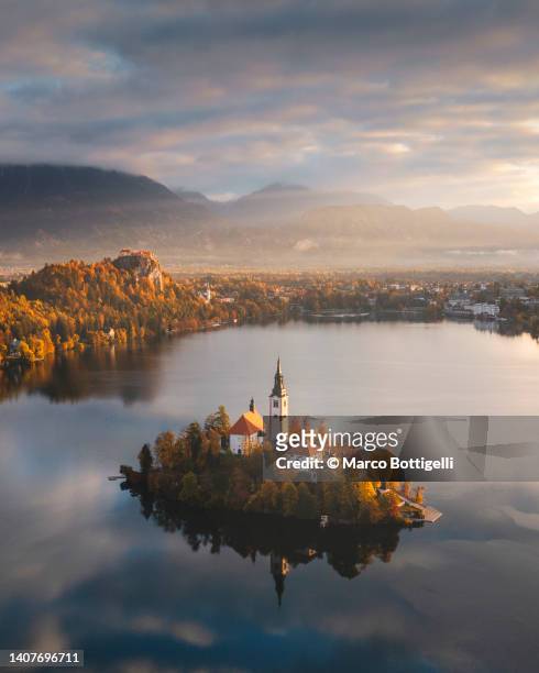 aerial view of lake bled church, slovenia - slovenia stock pictures, royalty-free photos & images