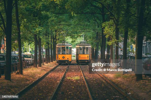 traditional old tram in milan, italy. - dual railway stock pictures, royalty-free photos & images