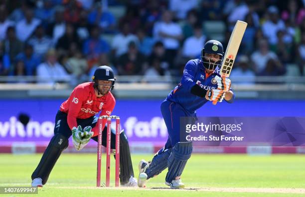 Ravindra Jadeja of India hits runs watched on by England wicketkeeper Jos Buttler during the 2nd Vitality IT20 between England and India at Edgbaston...