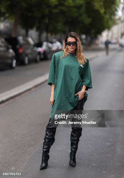 Valentina Ferrer is seen wearing a green oversized shirt, black leather pants, black high boots and sunglasses during Paris Fashion Week - Haute...