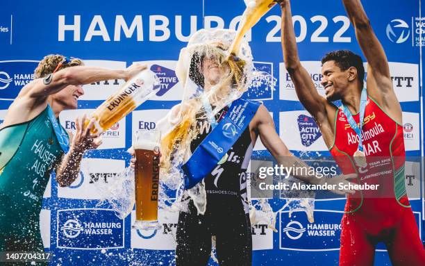 Matthew Hauser of Australia, Hayden Wilde of New Zealand and Jawad Abdelmoula of Marocco celebrateduring the Hamburg Wasser World Triathlon on July...