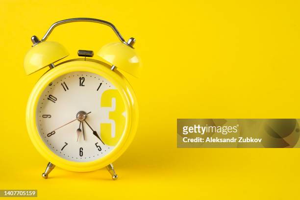 yellow alarm clock in retro style on a bright background. the concept of speed and rapidity of time and the flow of life. space for copying. - clockwork toy stock pictures, royalty-free photos & images