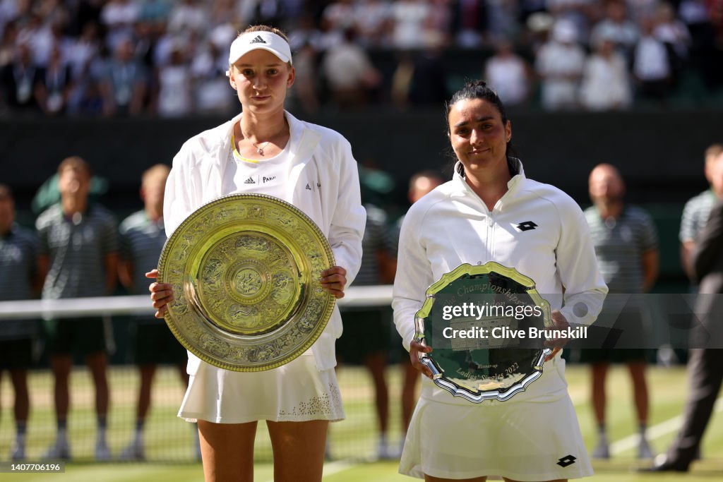 Poo Winets Elena Rybakina of Kazakhstan with the winners trophy and Ons Jabeur ...