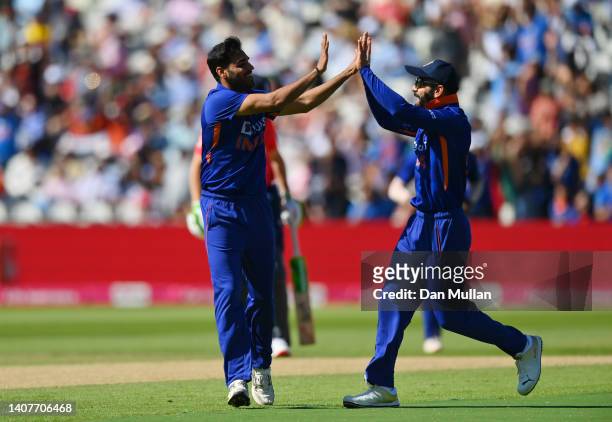 Bhuvneshwar Kumar of India celebrates with Virat Kohli after taking the wicket of Jason Roy of England during the 2nd Vitality IT20 between England...