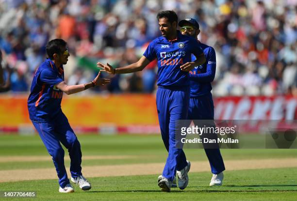 Bhuvneshwar Kumar of India celebrates with teammates after taking the wicket of Jason Roy of England during the 2nd Vitality IT20 between England and...