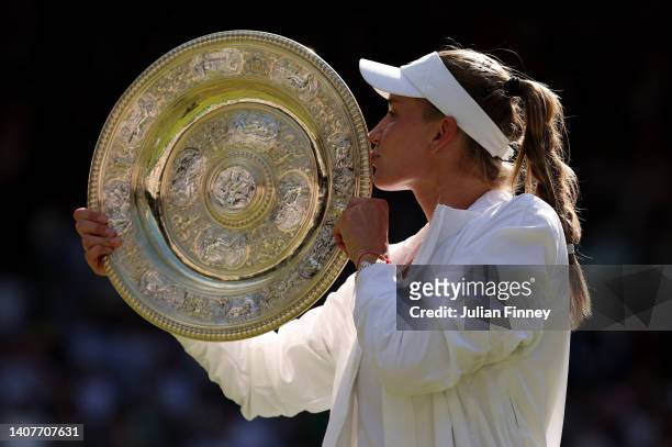 Elena Rybakina of Kazakhstan kisses the trophy after victory against Ons Jabeur of Tunisia during the Ladies' Singles Final match on day thirteen of...