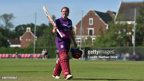 Kathryn Bryce of Lightning raises her bat after she scores 109* runs during the Rachael Heyhoe Flint Trophy match between Lightning and Thunder at...