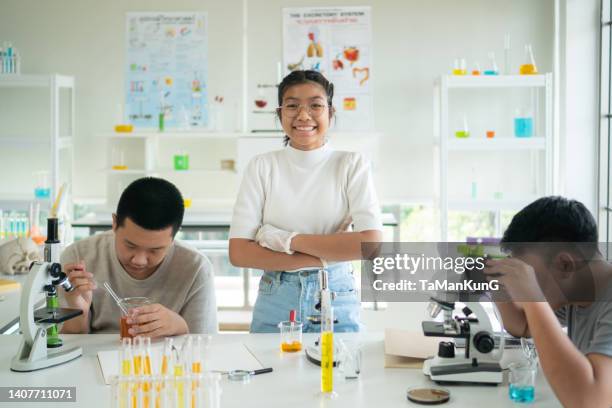 students are happily using a microscope to study science subjects. - children in a lab stock pictures, royalty-free photos & images