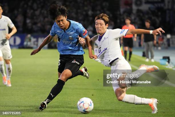 Hiroki Fujiharu of Gamba Osaka and Asahi Sasaki of Kawasaki Frontale compete for the ball during the J.LEAGUE Meiji Yasuda J1 21st Sec. Match between...