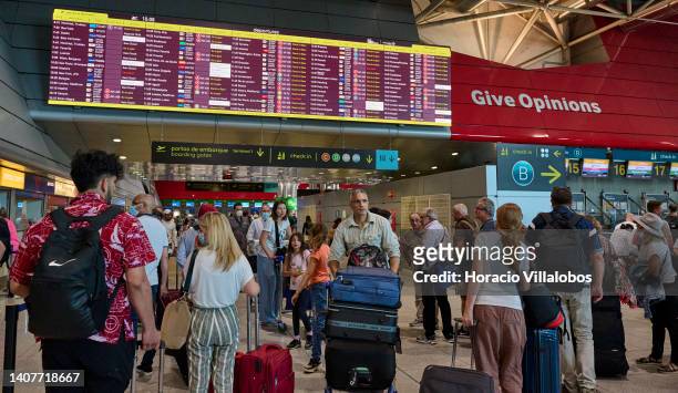 Travelers crowd Terminal 1 departures hall while while checking for departures in Humberto Delgado International Airport on July 09, 2022 in Lisbon,...