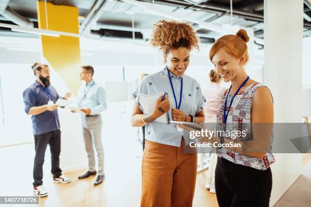 multiracial business team working together in office, brainstorming during coffee break - namnskylt bildbanksfoton och bilder