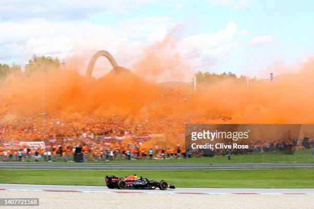 Sprint winner Max Verstappen of the Netherlands driving the Oracle Red Bull Racing RB18 waves as he passes his fans during the F1 Grand Prix of...
