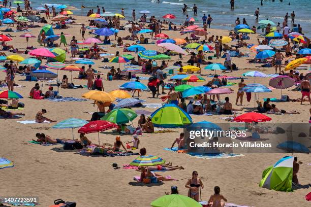 Beachgoers crowd Carcavelos Beach, near Lisbon, during a sunny and hot Saturday on July 09, 2022 in Carcavelos, Portugal. Temperatures above 30...