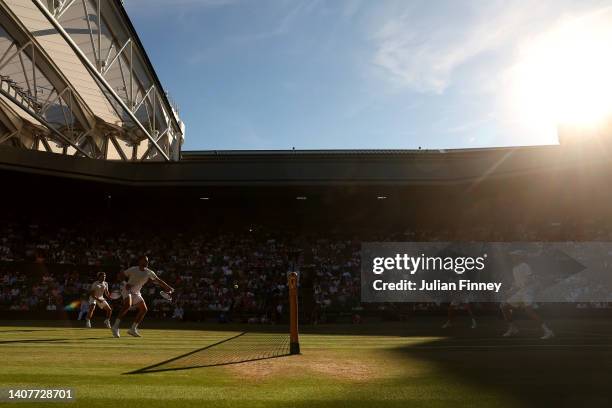 Mate Pavic of Croatia plays a backhand with partner Nikola Mektic of Croatia against Matthew Ebden of Australia and Max Purcell of Australia during...