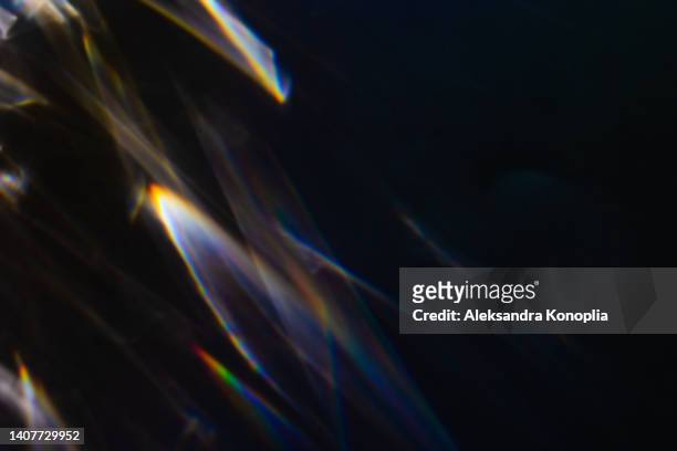colourful rainbow light leaks texture on black background - camera lens flare stock pictures, royalty-free photos & images