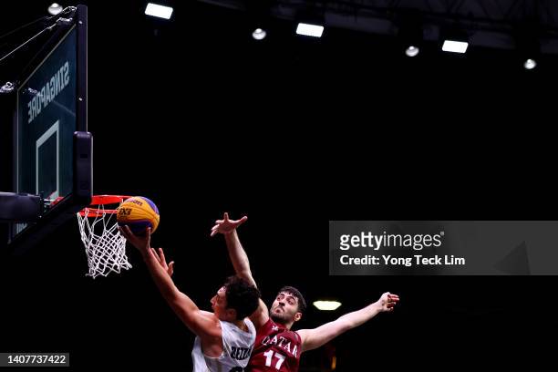Jayden Bezzant of New Zealand drives to the basket against Ahmad Saeid Mohamad of Qatar in their men's pool game during the FIBA 3x3 Asia Cup at...